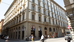 A multi-story building with large windows and arched doorways, likely a hotel or commercial property. - Florence Luxury Apartment al Duomo by Mmega (Florence)