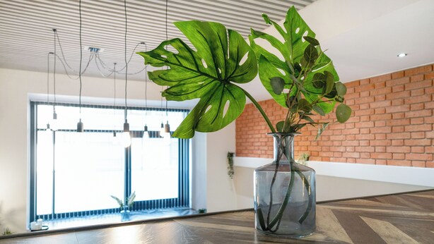 A modern interior with a large window, a brick wall, and a wooden floor. - Stay Angels Blonk Street Apartments (Sheffield)