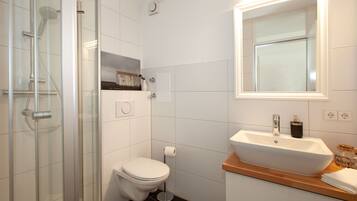 Shower, hair dryer, towels, toilet paper