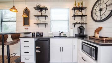 Fridge, microwave, coffee/tea maker, cookware/dishes/utensils