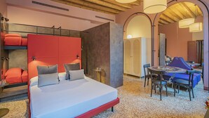 A modern bedroom with a bed, seating area, and a wooden ceiling. - Corte Rubbi 5 Deluxe Studio-Apartment (Venice)