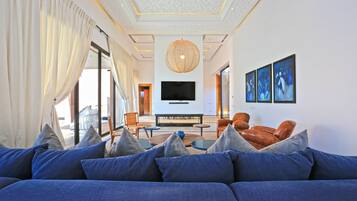 Villa, Multiple Beds | Living room | 30-inch TV with cable channels, fireplace