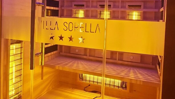 A glass-walled room with a bed, a window, and a sign reading "MILLA SORRELLA". - Villa Sorella Beautiful 3-bedroom Villa in Karanac (Knezevi Vinogradi)