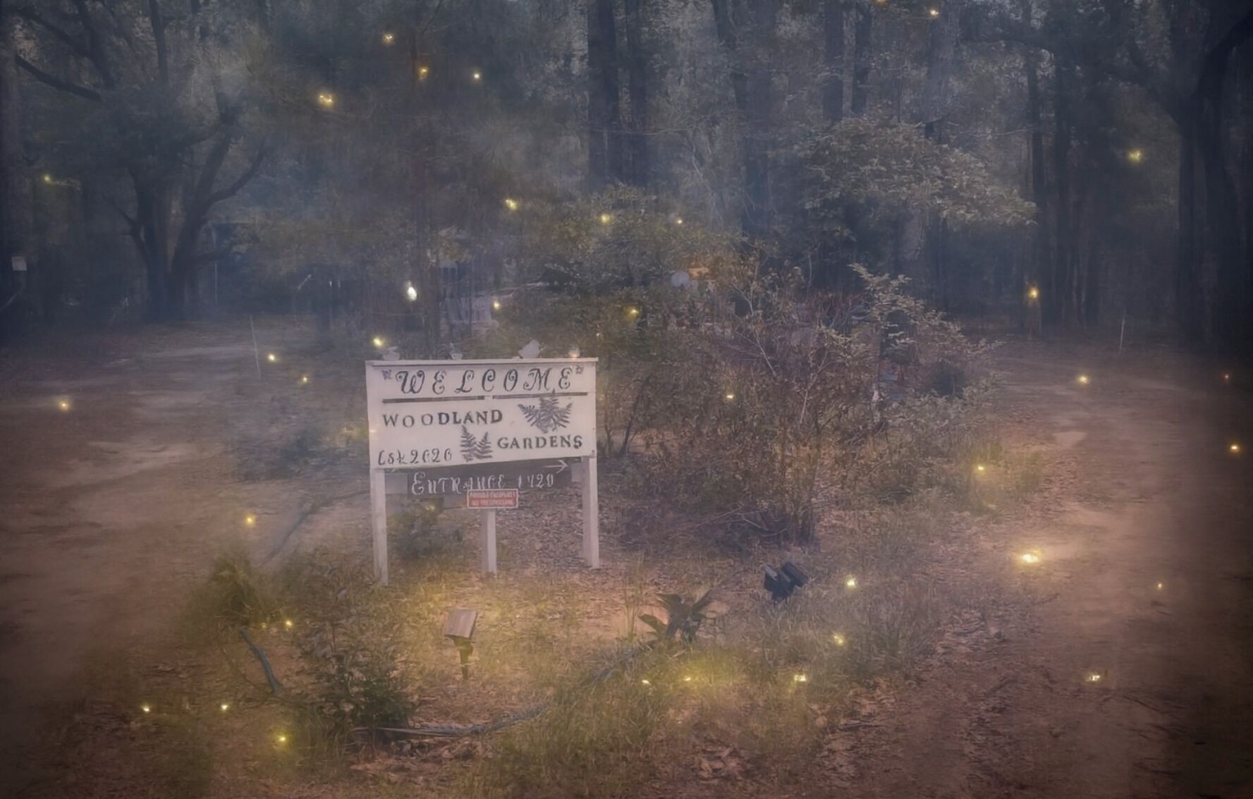A welcome sign for Woodland Gardens with an entrance number 1120.