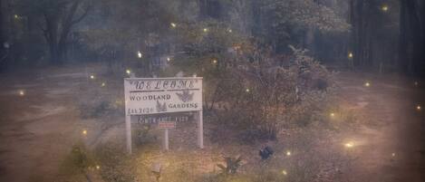 A welcome sign for Woodland Gardens with an entrance number 1120.