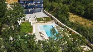 A two-story house with a swimming pool and a garden. - Villa with stunning underwater view, fenced private park (Imotski)