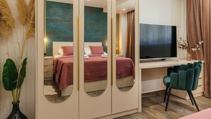 A modern bedroom with a bed, a TV, a desk, and a mirror. - Villa with stunning underwater view, fenced private park (Imotski)