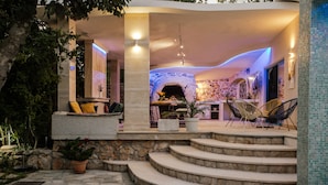 A modern outdoor patio with stone steps leading to a seating area with chairs and a table. - Villa with stunning underwater view, fenced private park (Imotski)