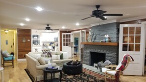 A living room with a fireplace, a sofa, a coffee table, and a rug.