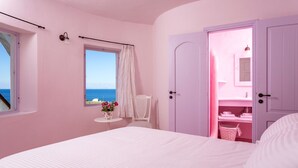A pink-themed bedroom with a bed, a window with a view, a small table with flowers, and a bathroom with pink lighting.