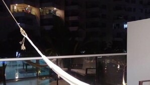 A hammock on a balcony with a pool and building views at night. - 1ME2 Apartamento en Morros Frente al Mar (Cartagena)
