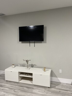 Relax in this stylish living room with a flat-screen TV and entertainment center.