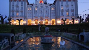 A large, ornate building with a central clock and multiple balconies. - Curia Palace Hotel Spa and Golf (Anadia)
