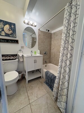 Combined shower/tub, hair dryer, towels, soap