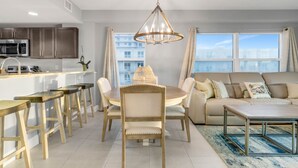 A modern living space with a kitchen, dining area, and seating area.