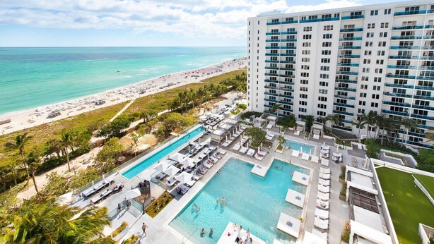 A hotel with a pool area, beach access, and a view of the ocean. - Luxurious 1/1 Ocean View Condo 1416 - Located at 1 Hotel & Homes South Beach (Miami Beach)
