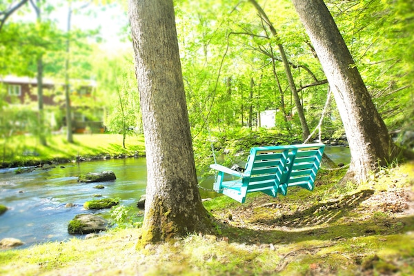 Cuddle with someone special on the streamside bench.