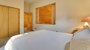 A bedroom with a large bed, wooden wardrobe, and a window with a wooden frame. - 2 Mi to Elk Mountain: Poconos Escape on 11 Acres! (Union Dale)