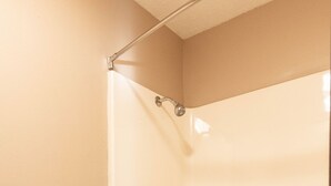A bathroom with a toilet, a bathtub, and a shower. - Lebo Inn (Waverly)