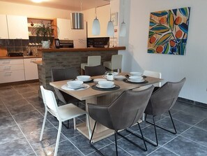 Enjoy meals in the kitchen with a stove and dining area featuring a wooden table and six chairs.