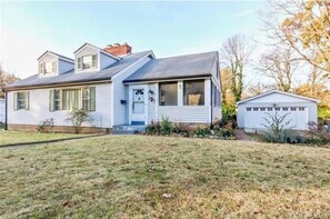 Stroll through the charming front porch of this single-story home, surrounded by a beautifully maintained lawn and a lush garden.