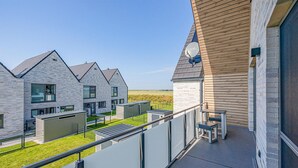 A modern residential building with a balcony featuring outdoor seating. - Stunning home in Büsum with sauna (Büsum)