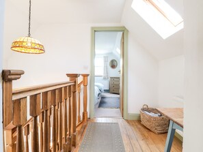 A wooden staircase with a glass door leading to a bedroom. - 1 The Terrace (Clynderwen)