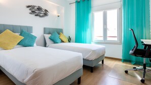 A hotel room with two beds, a desk, and a chair. - Lagos Workation Apartment (Lagos)