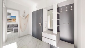A modern bathroom with a large mirror, a vanity, and a shower area.