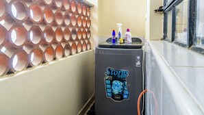 A compact room with a small refrigerator labeled 'Storm' and a wall with circular cutouts. - Hirwado Homes - QUIET/Secure/15 Mins to JKIA /SGR (Mlolongo)