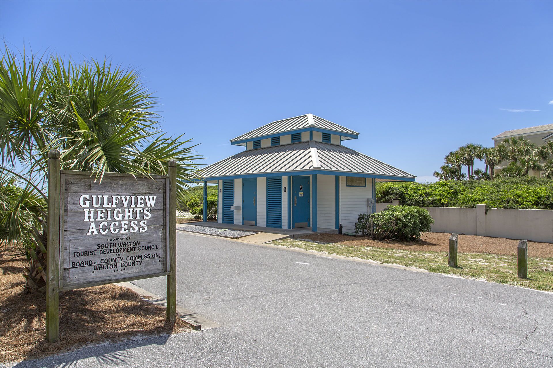 A small building with a blue and white striped roof, labeled as 'GULFVIEW HEIGHTS ACCESS.'