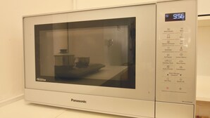 A Panasonic microwave oven with a digital display showing 9.56, a timer set to 10 minutes, and various cooking options.