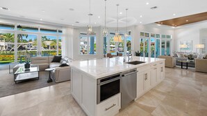 A spacious kitchen with a large island, modern appliances, and ample natural light.