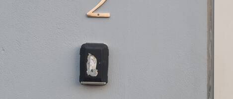 A door with a number '2' sign, a peephole, and a keyhole.