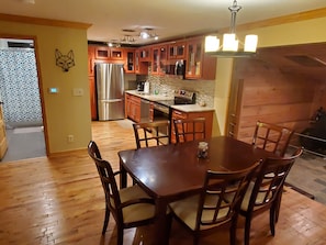 Enjoy meals in the kitchen with a central island and dining area featuring a wooden table and six chairs.