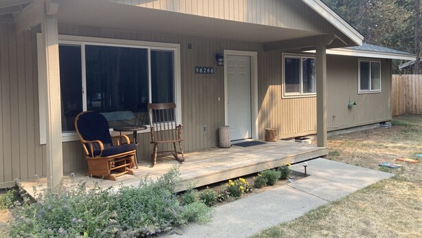 A single-story house with a covered porch, a front door, and a mailbox. - Wooded river retreat near Mt. Bachelor and Bend (Bend)