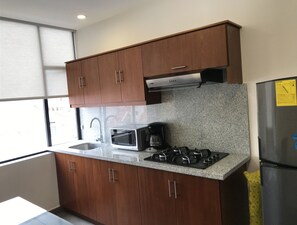 Fridge, microwave, stovetop, coffee/tea maker