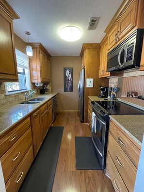 Enjoy cooking in this well-equipped kitchen with a refrigerator, oven, microwave, and coffee maker.