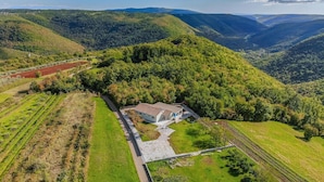 A house surrounded by lush green hills with a clear sky. - Stunning home in Zminj (Zminj)