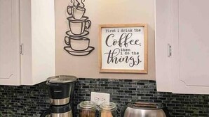 A kitchen with a coffee maker, jars, and a toaster on the counter. - Right in Nashville, One of the last standing farms (Nashville)