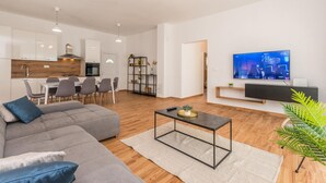 A modern apartment with a living room, dining area, kitchen, and a TV. - Pet friendly home in Radasinovci (Radasinovci)