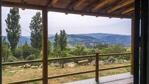 A covered outdoor area with a view of a hilly landscape, featuring a metal railing and a tiled floor. - Nice home in Algatocin (Algatocin)