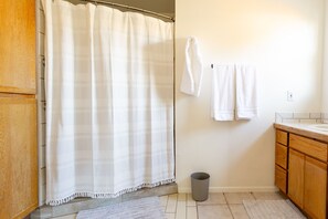 Bathtub, hair dryer, towels, soap
