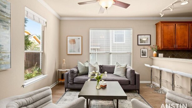 A spacious living room with a gray sofa, a coffee table, and a ceiling fan. - 8th #B xxxxxxxxxxxxx (Austin)