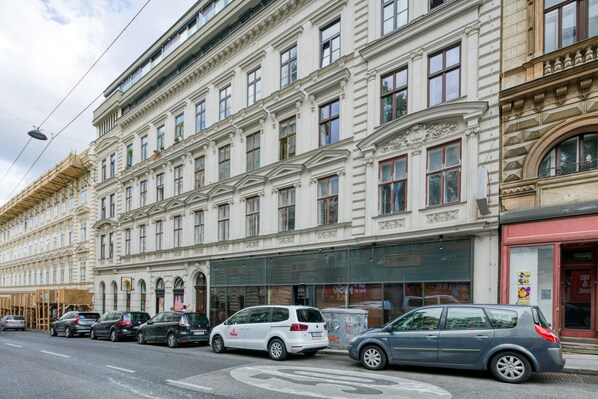 A multi-story building with classical architecture, featuring large windows and ornate detailing.