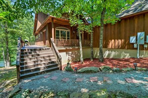 Escape to a secluded cabin nestled in a lush forest, featuring a welcoming porch and natural surroundings.