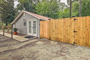 Cozy retreat with a small shed, surrounded by a garden and a wooden fence.