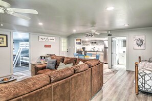 Relax in this inviting living space with a comfortable sofa, dining area, and kitchen counter.