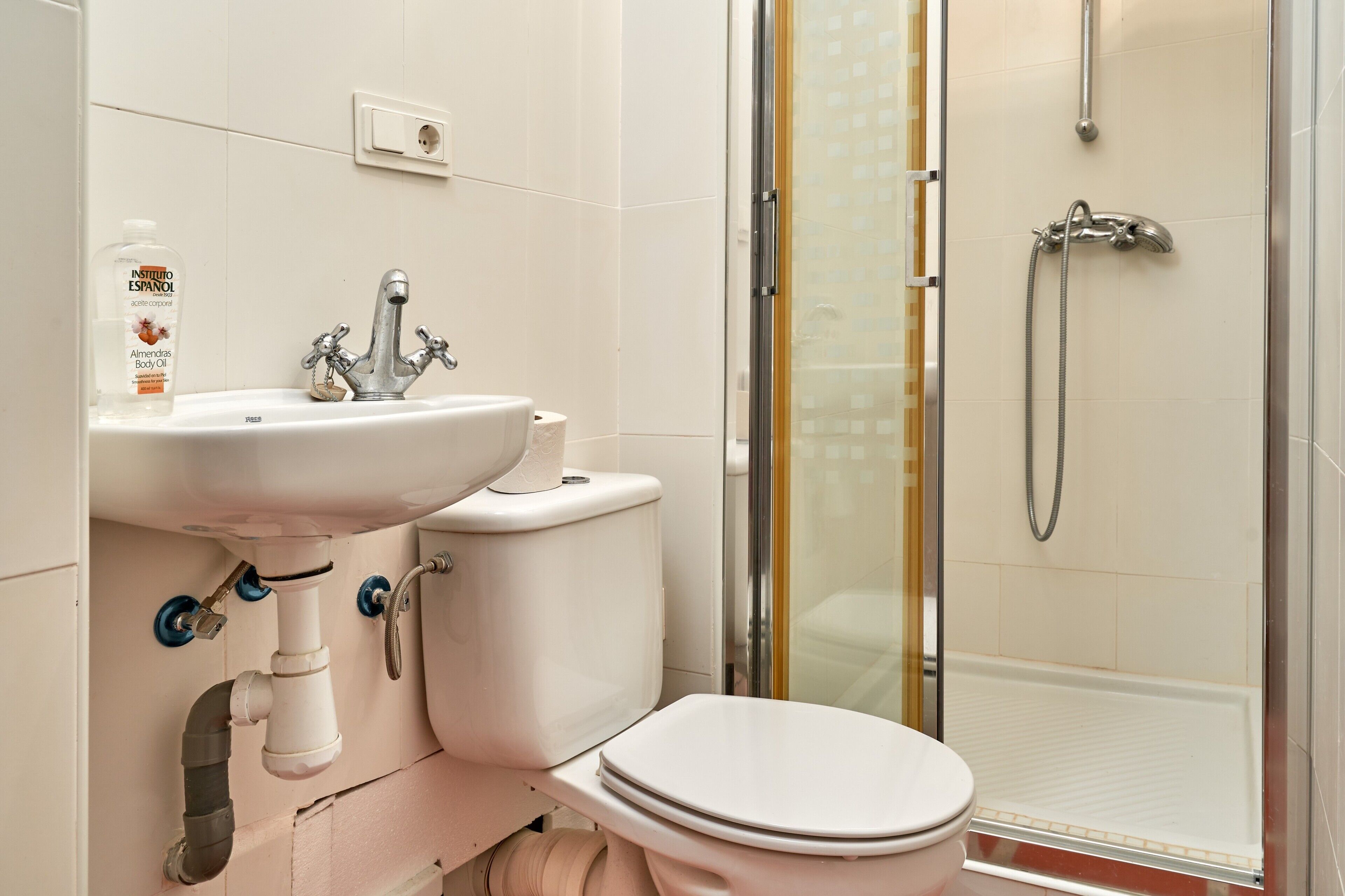 A bathroom with a sink, toilet, and shower.
