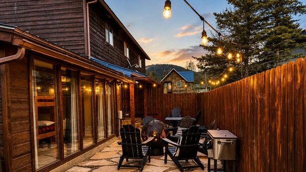 A wooden house with a stone patio, outdoor seating, and a fire pit. - Mountain Memories, Walk to Ski Area, Town, Fishing (Red River)